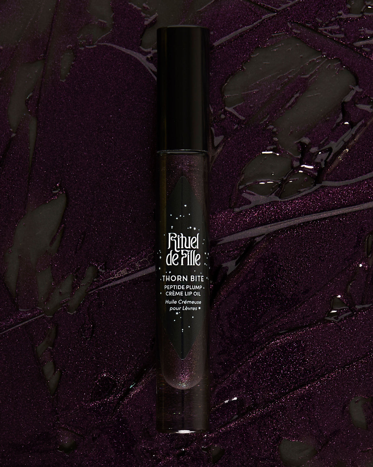Campaign image featuring model wearing Night Bloom lip oil